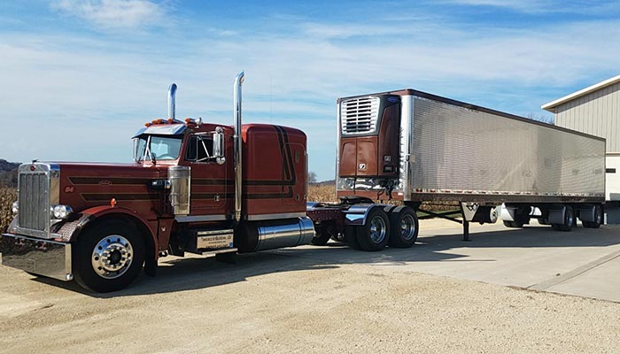 Peterbilt semi truck tractor trailer with reefer as part of JDK Logistics nationwide freight transportation broker fleet