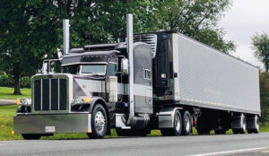 Peterbilt semi truck tractor trailer with reefer as part of JDK Logistics nationwide freight transportation broker fleet