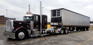 Peterbilt semi truck tractor trailer with reefer as part of JDK Logistics nationwide freight transportation broker fleet