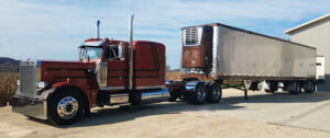 Peterbilt semi truck tractor trailer with reefer as part of JDK Logistics nationwide freight transportation broker fleet