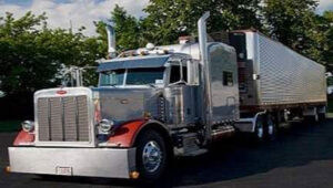 Peterbilt semi truck tractor trailer with reefer as part of JDK Logistics nationwide freight transportation broker fleet